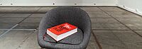 Chair with red book titled Imagine: Reflections on peace