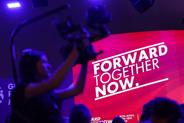 Decorative image showcasing cameraman and screen with the slogan "Forward, together, now".