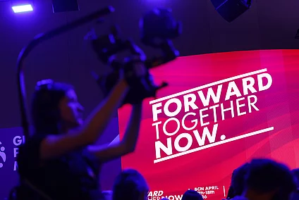 Decorative image showcasing cameraman and screen with the slogan "Forward, together, now".